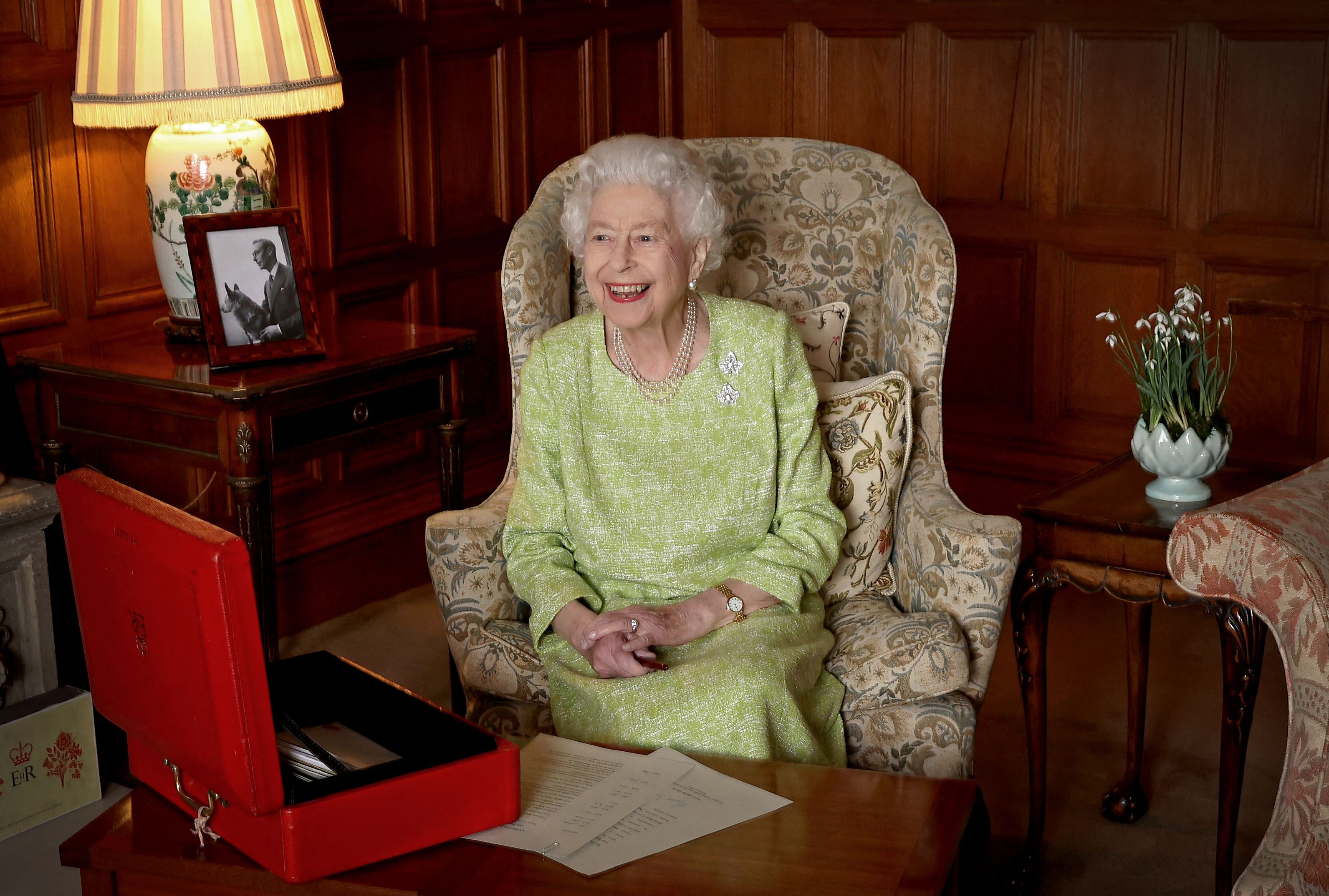 <p>Buckingham Palace released this image of Queen Elizabeth II on Feb. 6, 2022 -- her Accession Day marking 70 years on the throne and the start of her Platinum Jubilee year -- showing her smiling as she worked on papers from her iconic red box inside Sandringham House in Norfolk, England, on Feb. 2, 2022. Accession Day, she wrote in a letter released on the eve of the anniversary, "is a day that, even after 70 years, I still remember as much for the death of my father, King George VI, as for the start of my reign." </p>