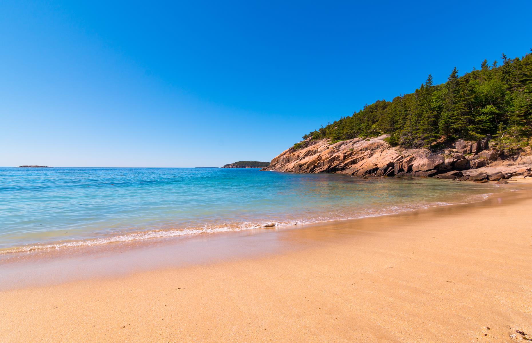 <p>The 27-mile (43km) section that makes up Park Loop Road is the most scenic of all. This portion of the route runs within the limits of Acadia National Park – it travels by Sand Beach (pictured), a golden inlet along the rocky shoreline, and Otter Cliff, a striking 110-foot-high (34m) headland that draws many a budding photographer. Make time for a walking tour of downtown Bar Harbor too.</p>  <p><a href="https://www.loveexploring.com/gallerylist/87456/americas-most-charming-seaside-towns"><strong>America's most beautiful seaside towns</strong></a></p>