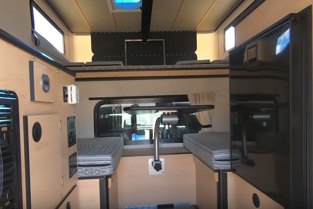 <p>At just 6.5 feet long, a typical camper portion is tighter than some of the RVs on this list, but it’s enough for couples who don’t mind roughing it a bit. Features include a queen-sized bed in the loft over the cab, plus a small kitchenette, and dining area. Toilet and shower are optional (space is tight, after all). </p>