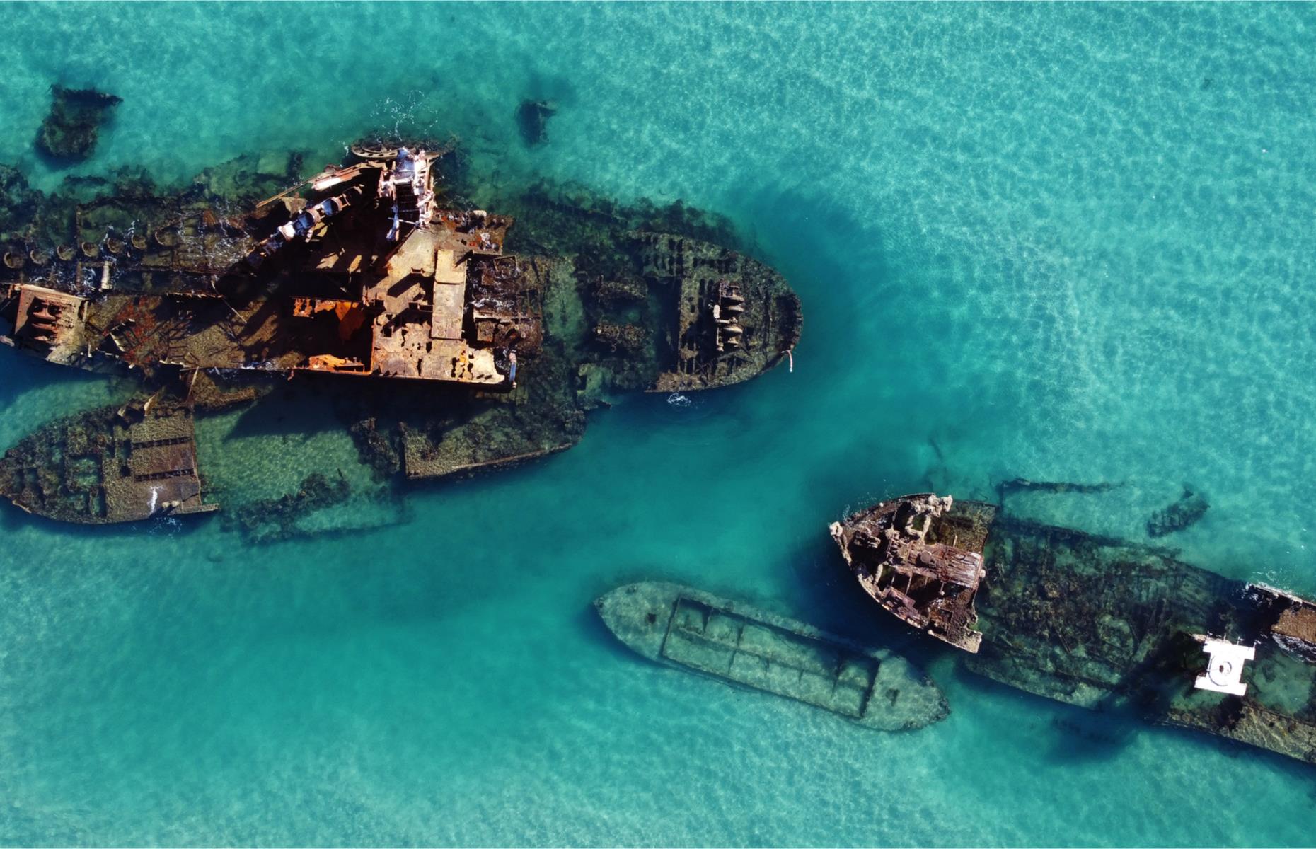 A group of scuttled ships lie just off Moreton Island, north of Tangalooma Island Resort. Known as the Tangalooma Wrecks, the decommissioned vessels were sank by the Queensland government between 1963 and 1984 to create a safe anchorage spot for boat owners. Their water-logged carcasses are now a popular dive and snorkeling site and are alive with assorted reef fish and coral formations, and drawing other marine life including dolphins, wobbegongs and dugongs.
