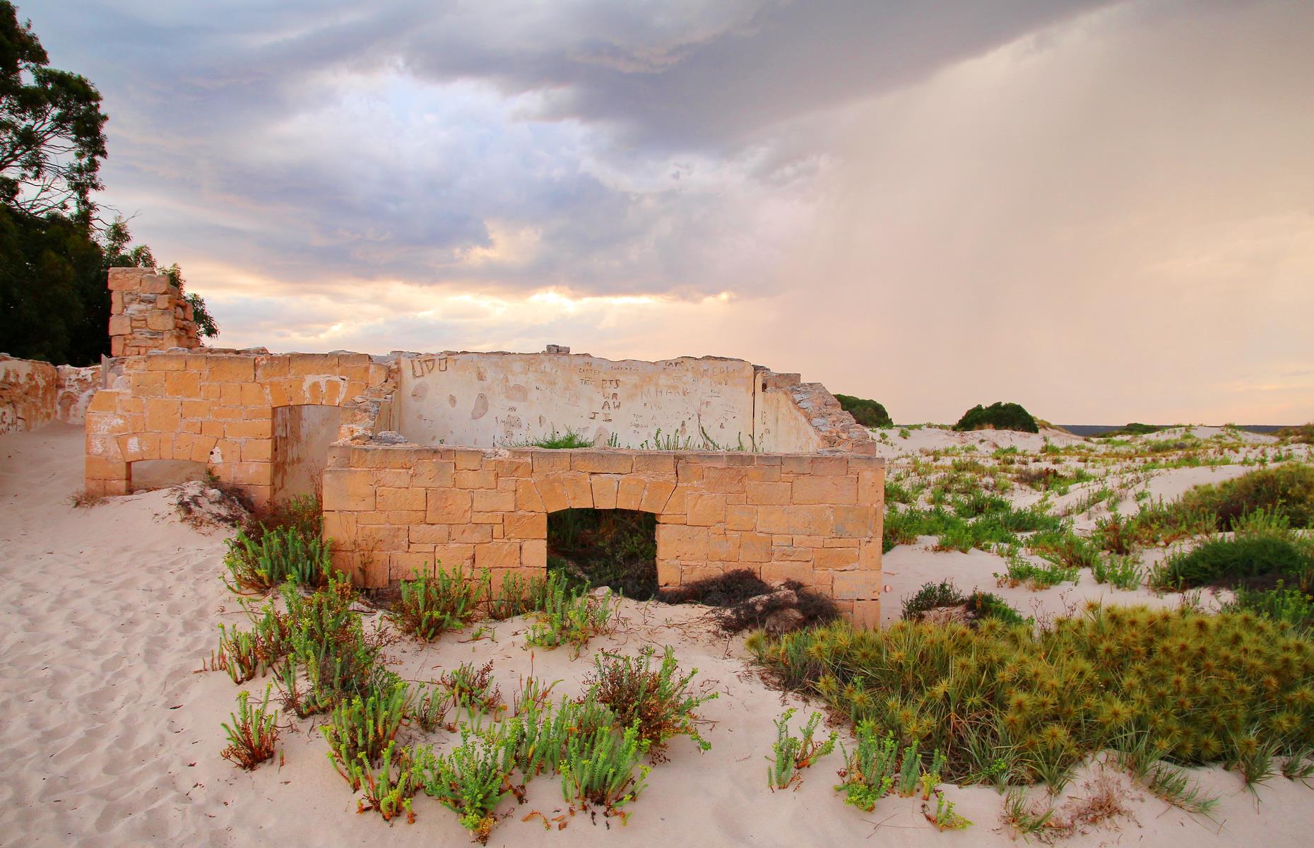 <p>Almost submerged beneath the shifting sand dunes sits what's left of an old telegraph station. Located in what's now isolated Eucla, the original township in the Nullarbor Plain was established in 1877 as a manual repeater station for the overland telegraph. It was the largest telegraph station outside of the main cities. All that remains of the town lies under the sand, due to large sand drifts caused by a plague of rabbits eating the dune vegetation. These sand-strewn ruins are said to be haunted by a ghost – perhaps a ghostly rabbit?</p>