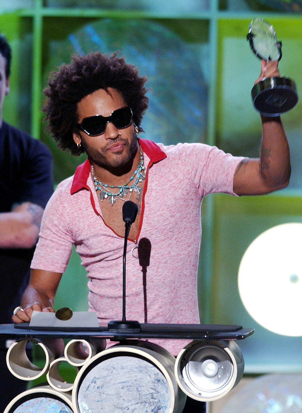 <p>Lenny Kravitz accepts the award for Artist of the Year: Pop Alternative Radio, at the Radio Music Awards in Las Vegas. He wore red polo and turquoise jewelry.</p>