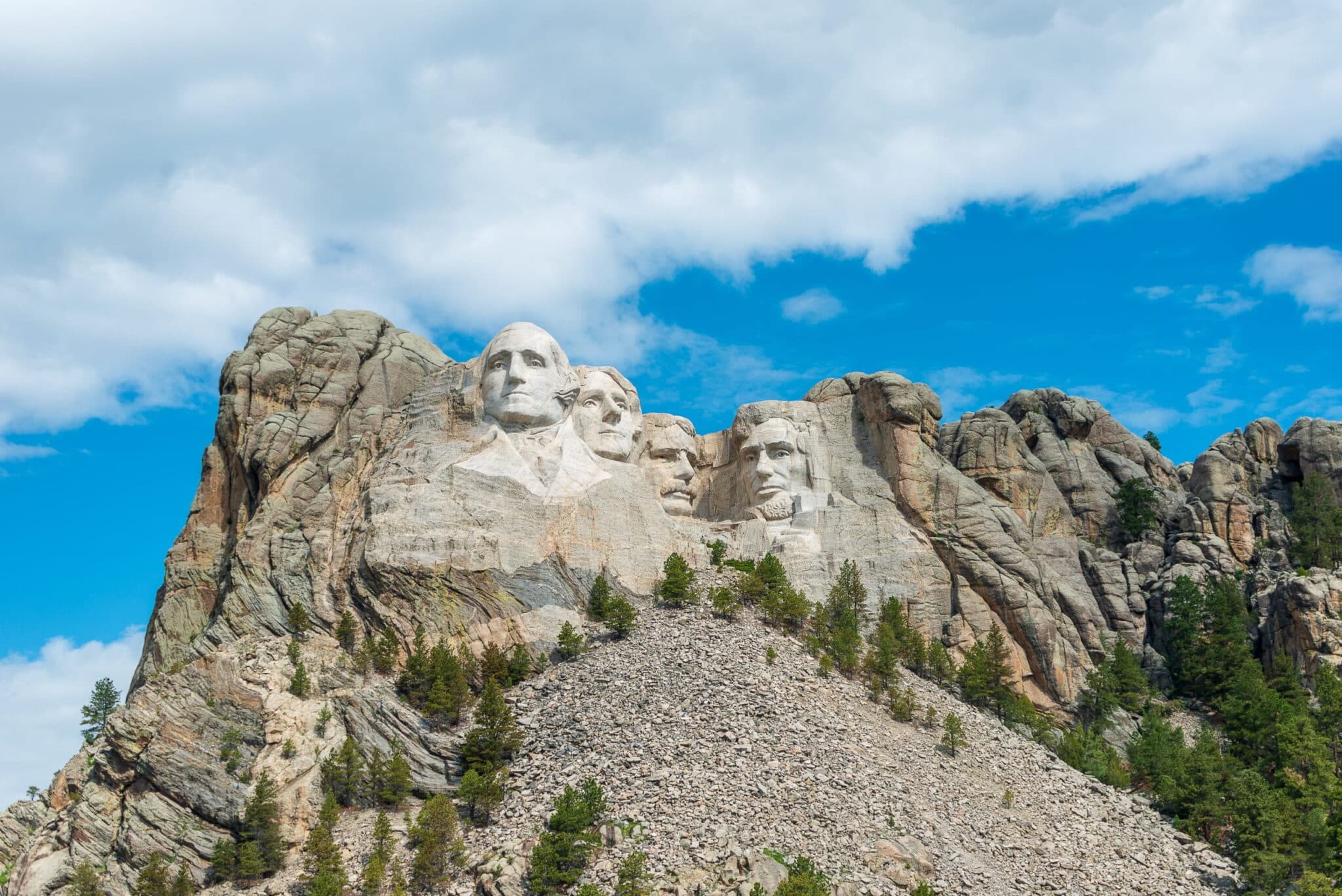 <p>Consider taking a road trip through South Dakota's rolling prairies, twisting mountain roads, and iconic American monuments. Start at historical Mount Rushmore and Crazy Horse Memorial. Take US-16 E to enjoy a couple of days in Rapid City, a vibrant town with outdoor festivals, concerts, and a unique food scene. Travel I-90 E to Wall as a base for exploring Badlands National Park. Drive the Badlands Loop Scenic Byway to see its 16 stunning overlooks and hike among its surreal landscape.</p>