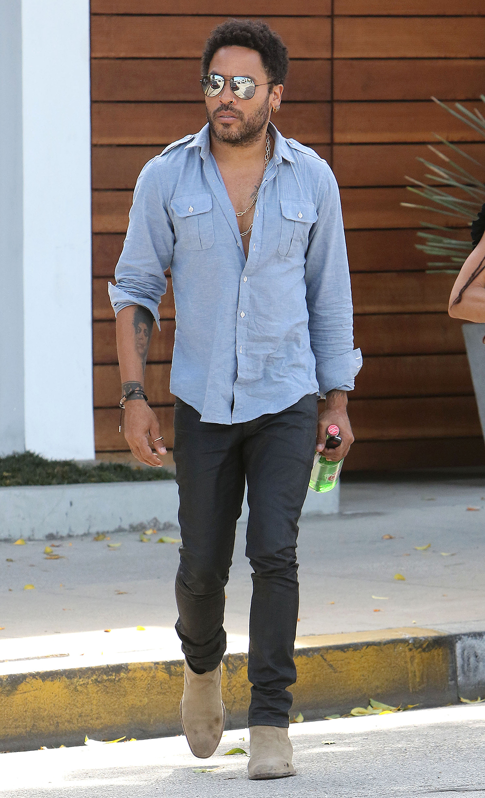 <p>Lenny Kravitz hangs out with ex Lisa Bonet in LA on Mar. 13, 2015. He wore a blue shirt open to reveal his chest.</p>