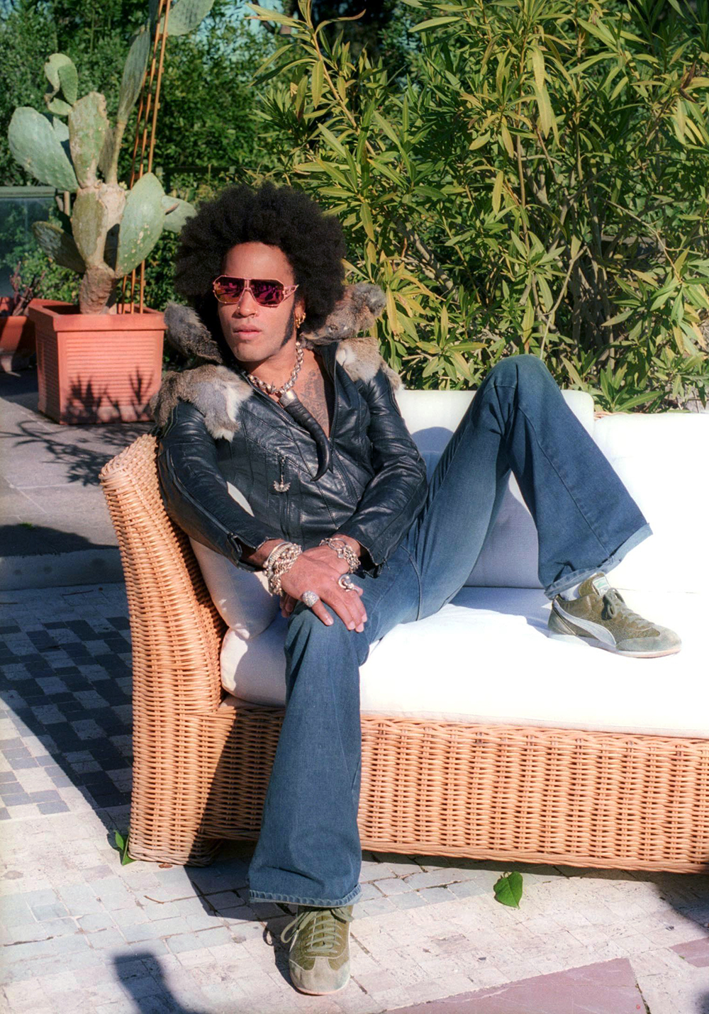 <p>Lenny Kravitz is relaxed during a photoshoot in Rome on Feb. 22, 2002. He wore bell bottom jeans for a very 70s attitude.</p>