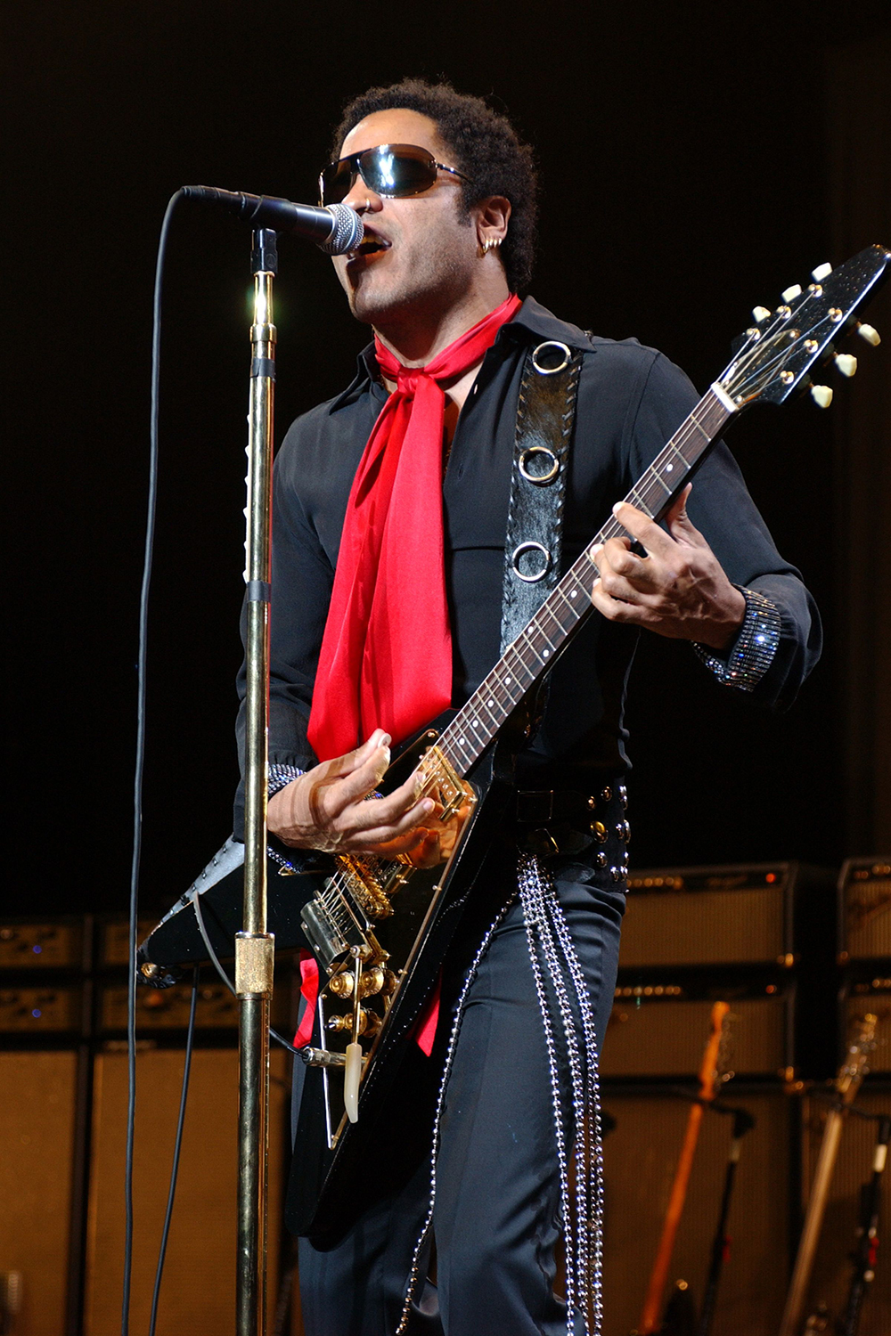 <p>Lenny Kravitz wears a red scarf while performing in Miami Beach, Florida on Apr. 13, 2005. His Flying V guitar was very rock and roll.</p>