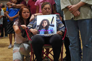 A woman holds a photo of Nevaeh Bravo, who was killed in the mass shooting at Robb Elementary School, during a vigil for the victims in Uvalde, Texas, on May 25.