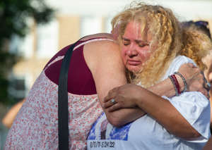 relatives of Uziyah Sergio Garcia embrace each other during a prayer service at the Uvalde Town Square in Uvalde, Tex., on May 28, 2022. Garcia was one of 19 children gunned down at Robb Elementary School.