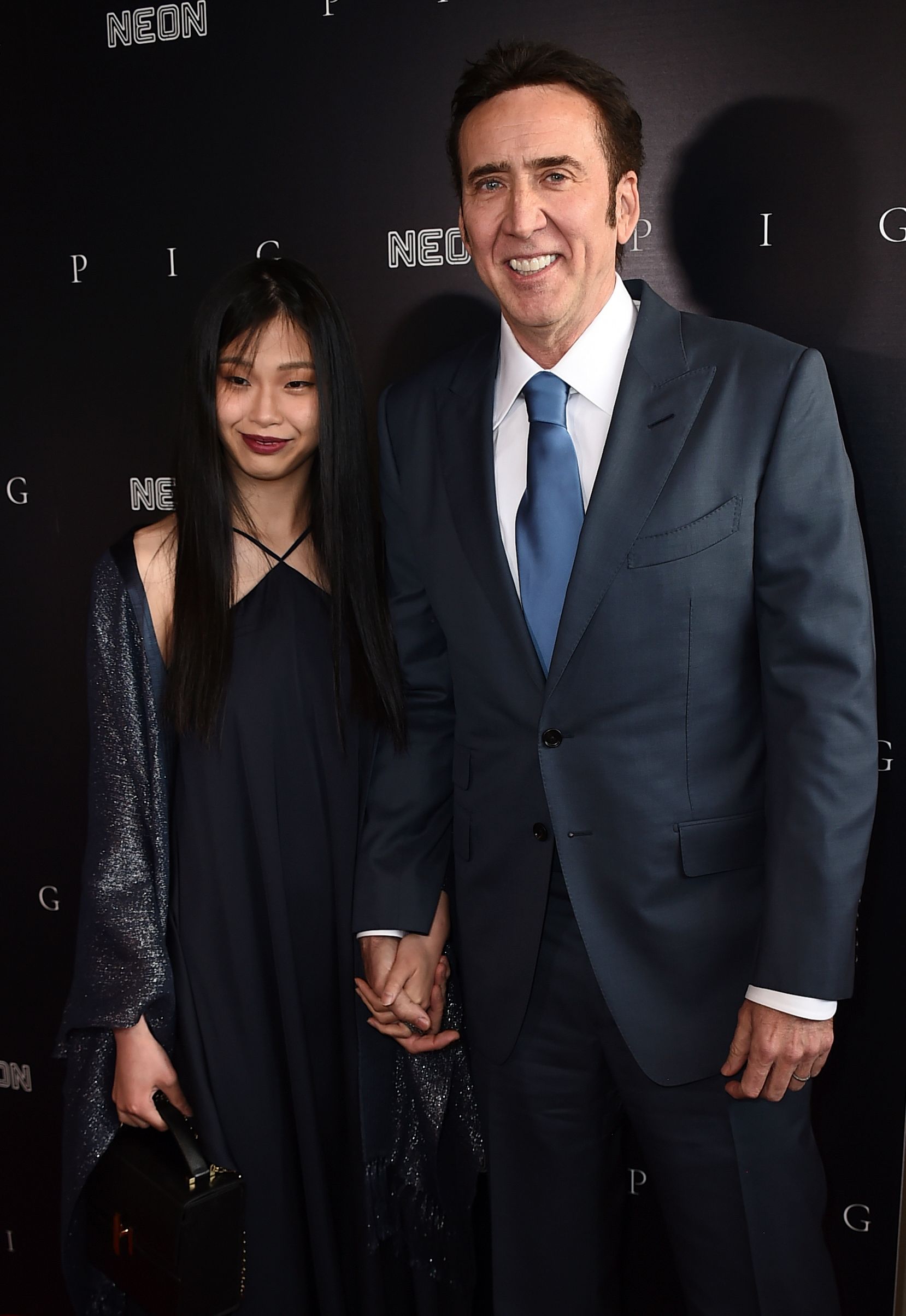<p>Nicolas Cage fell for the woman who <a href="https://www.wonderwall.com/celebrity/couples/celebrity-weddings-of-2021-famous-people-who-got-married-this-year-465325.gallery?photoId=465443">became his fifth wife</a> while he was visiting her native country sometime in 2019. "We met in Japan and I thought she was stunning when I met her. We had a lot in common," Nic told <a href="https://www.etonline.com/nicolas-cage-says-wife-riko-shibatas-pet-flying-squirrels-had-a-hand-in-their-love-story-exclusive">"ET"</a> in July 2021. "She likes animals too, so I asked her, 'Do you have any pets?' And she said, 'Yes, I have flying squirrels.' She had two sugar gliders... <a href="https://www.wonderwall.com/news/nicolas-cage-said-flying-squirrels-attracted-him-to-fifth-wife-475858.article">I thought, 'That's it. This could work out.'"</a> He proposed in 2020 in the midst of the coronavirus pandemic. "She left New York [where she was visiting me] and went back to [her hometown of] Kyoto, Japan, and I went back to Nevada and I haven't seen her for six months [due to pandemic restrictions]," he explained on brother Marc "The Cope" Coppola's <a href="https://www.youtube.com/watch?v=Lvj7EuW6vA4&t=15s">Q104.3 radio show</a> in August 2020. "We were really happy together ... so I finally just said, 'Look, I wanna marry you,' and we got engaged on FaceTime. And I got her a black diamond engagement ring -- 'cause her favorite color is black, she wanted the black gold and the black diamond, so I found it and customized it and personalized it. I actually sent it to her via FedEx." The couple wed in Las Vegas in February 2021.</p>
