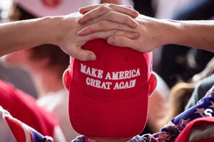 A man wearing a "Make America Great Again" hat waits for President Donald Trump to arrive for a campaign rally at Williamsport Regional Airport on May 20, 2019, in Montoursville, Pa.