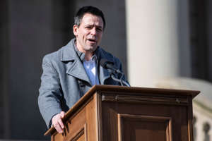 Republican gubernatorial candidate Ryan Kelley speaks during a protest outside of the Michigan State Capitol in Lansing demanding a forensic audit on Feb. 8, 2022.
