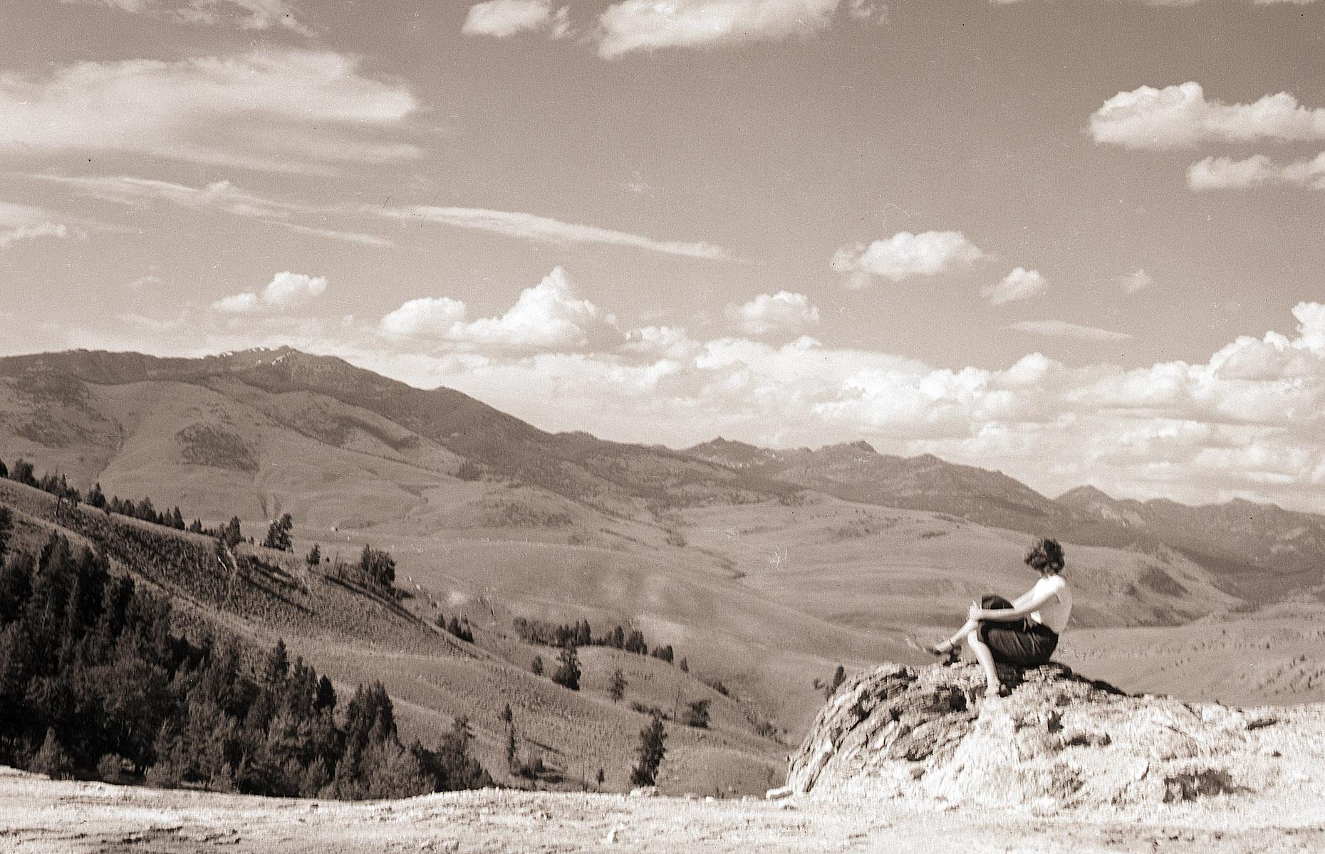 Visitation soared through the 1950s and the National Park Service launched Mission 66. The project aimed to rebuild a park system devastated by war – a whole decade was spent sprucing up facilities and expanding services available to visitors across all national parks, including Yellowstone. A lone woman admires the rugged landscape in this photograph from 1955, when Mission 66 was launched.