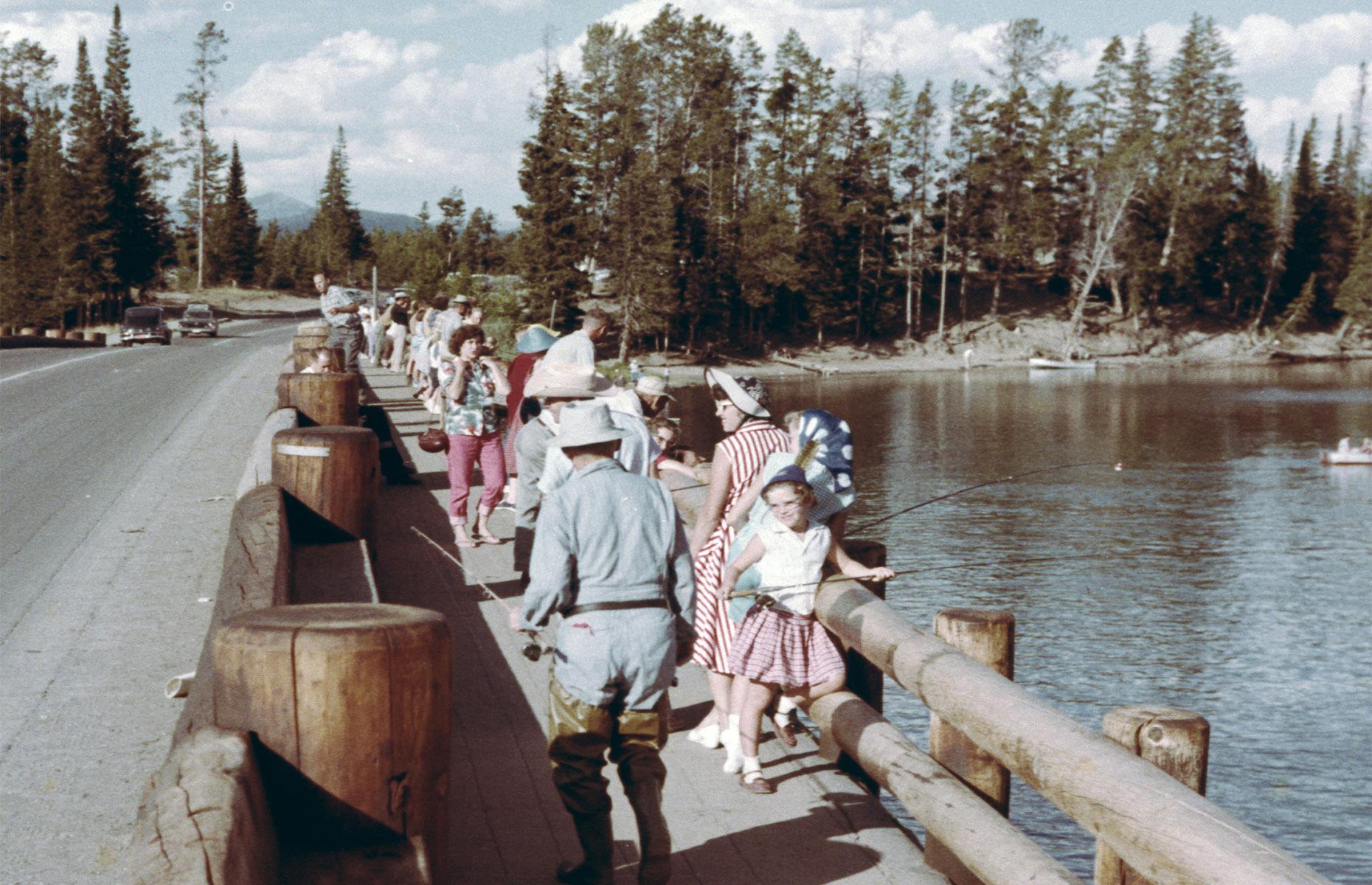 Yellowstone's original Fishing Bridge was built as early as 1902, though the current structure dates to 1937. During the first half of the 20th century, it was the park's star spot for trout fishing – however, dwindling populations meant that fishing was banned here in 1973. Visitors are pictured here enjoying the bridge in 1975 and its sweeping views over Yellowstone Lake still draw the crowds today.