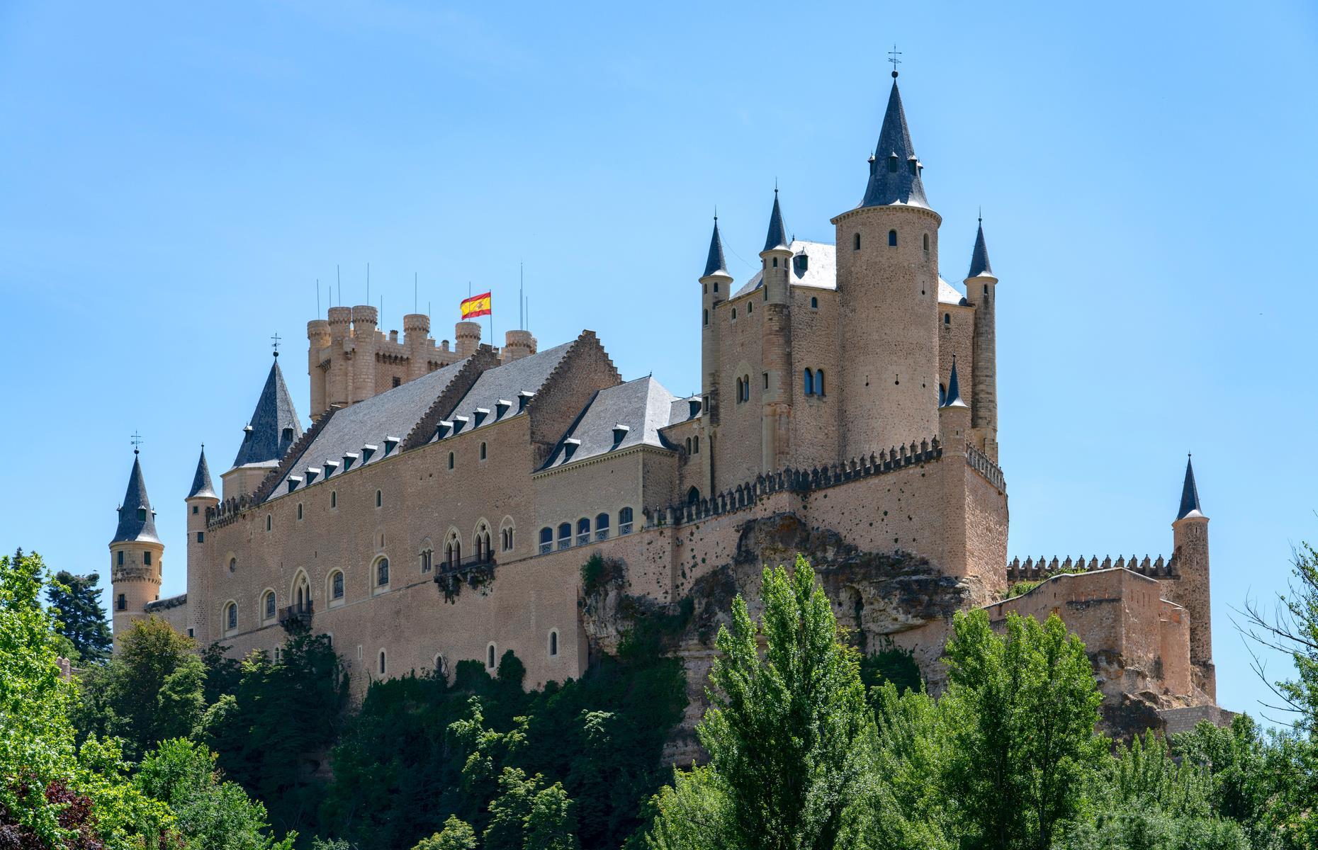 <p>The formidable Alcázar of Segovia was allegedly central to Walt Disney’s vision for the Evil Queen’s pointy stone castle in the 1937 film <em>Snow White and the Seven Dwarfs</em>. Perched on a rock with a white façade, witches hat towers and deep moat, the part-Moorish, part-19th-century fortress is everything you could want from a wicked queen’s lair.</p>
