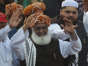 FILE - Maulana Fazlur Rehman (C), leader of the Pakistan Democratic Movement (PDM), waves to supporters during an anti-government demonstration to protest against inflation, unemployment and other economic issues in Karachi on November 13, 2021.