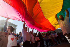 Same-sex marriage supporters hold up a giant flag in front of the Supreme Court in 2015 as the court prepared the hear oral arguments in Obergefell v. Hodges.