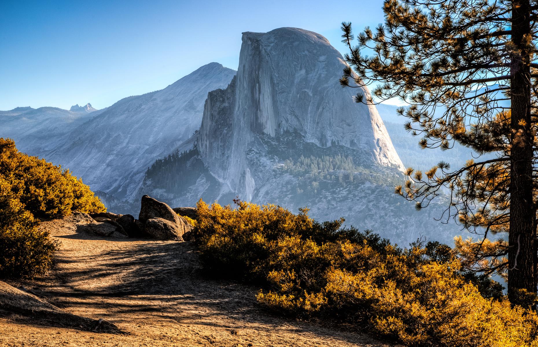<p>The most famous image of <a href="https://www.nps.gov/yose/index.htm">Yosemite National Park</a>, Half Dome's distinctive bulk rises some 5,000 feet (1,524m) above the valley floor. Reaching the summit is no small feat and the 16-mile (26km) round-trip route is best left to competent hikers. It should take around 12 hours, with a near-vertical 400-foot (122m) cabled section taking you to the very top. If you'd prefer to drink in the famous rock face from a distance, Glacier Point offers views of Half Dome and some spectacular waterfalls.</p>