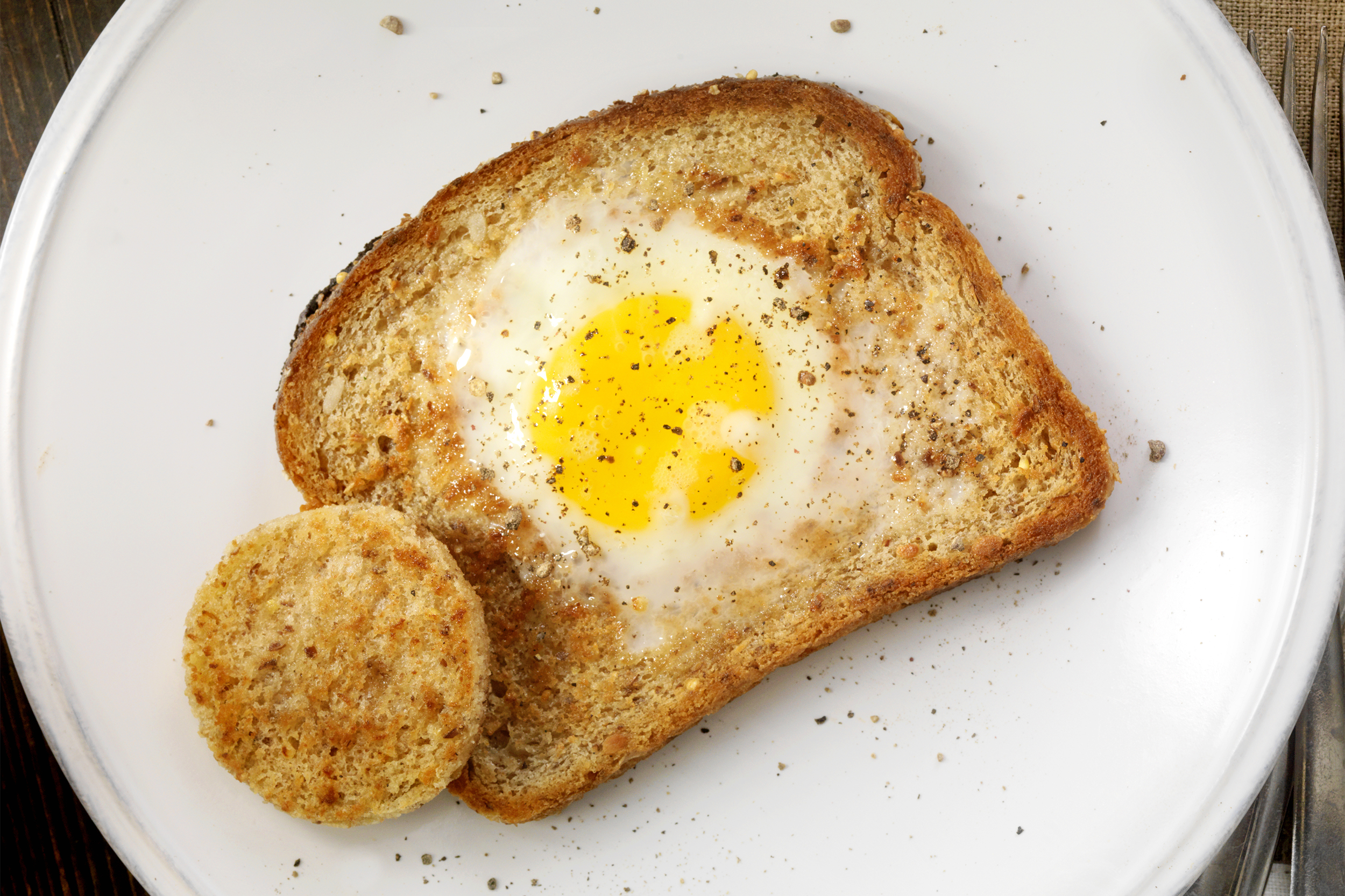 <p>It's really just another way to have toast with your eggs, but people love it: Cut a hole in bread, toast each side in a lightly oiled skillet, break eggs into each hole, cover the pan to let it sit for roughly five minutes so the eggs set. Salt and pepper to taste afterward.</p>