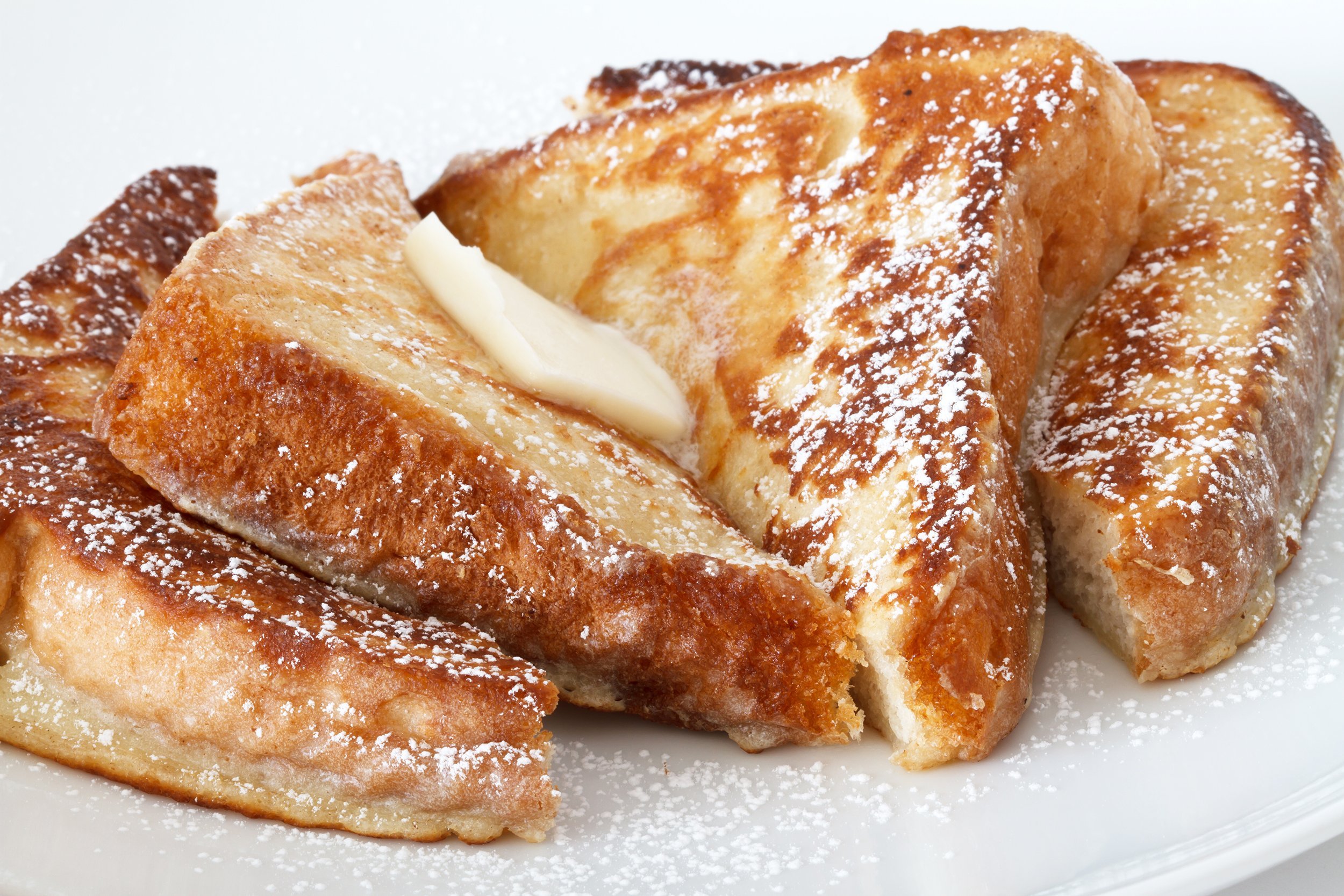 <p>There are many ways to make French toast, but the basic idea is to mix eight eggs and one-third cup of milk in a bowl — spices such as nutmeg are optional — and soak slices of bread in it that can be heated until golden brown on a lightly greased, large nonstick skillet over high heat. Don't forget to preheat, and to let the bread stand a bit before going on the skillet for two to three minutes per side. Any bread will work, including slightly stale bread, and you can get creative with mix-ins and toppings.</p>