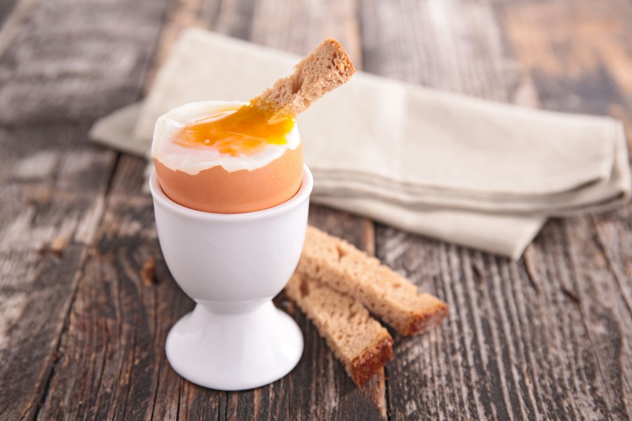 <p>Soft-boiled eggs are also easy to make, and take less time than hard-boiled eggs, but need to be served in eggcups. If eggcups are unavailable, make do with a ramekin or teacup filled with dry rice or other small grains. To soft-boil eggs, follow the directions for hard-boiled eggs but let the eggs sit in the water for only 2 to 3 minutes. Although soft-boiled eggs can be eaten on their own, they're more popular as a sort of dipping sauce for toast — always <a href="https://blog.cheapism.com/best-brunch/">a fun, tasty addition to brunch</a>. To eat, place the soft-boiled egg with the smaller end facing upward. Gently crack the shell near the top, and either scoop out the runny insides with a spoon or dip toast directly inside the soft, runny parts of the egg.</p>