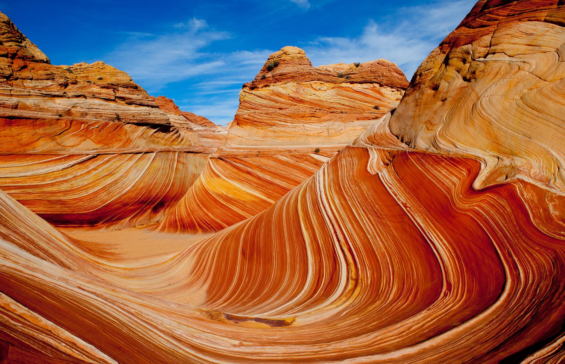 <p>Sometimes nature throws a real curveball. In this case, she threw a spinning, swirling, spectacular googly. Photos of this peaches-and-cream sandstone rock formation look like paintings. You can only access the Wave in the Vermillion Cliffs National Monument by entering the permit lottery and if selected, there is a recreation fee to pay when visiting as well.</p>  <p><a href="https://www.loveexploring.com/galleries/131865/exclusive-access-americas-best-travel-destination-lotteries?page=1"><strong>Take a look at America's best travel destination lotteries</strong></a></p>