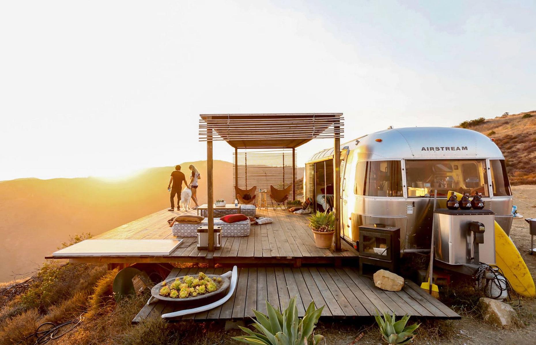 <p>This Airstream – available for <a href="https://www.airbnb.co.uk/rooms/3406062">rent via Airbnb</a> – is located on a private bluff in Malibu, California with brilliant views out to the ocean. The trailer has been reconfigured as a large luxury studio with a high-end kitchenette, bathroom and queen-sized bed and it's furnished with cozy wool rugs, cushions and blankets for chilling on the deck.</p>