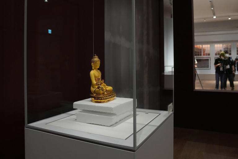 A copy Buddha statue sits on display during a preliminary showing at the Hong Kong Palace Museum in Hong Kong, Tuesday, May 10, 2022. Hong Kong Palace Museum will exhibit over 900 art collections from the China's Palace Museum of the Beijing's Forbidden City. (AP Photo/Kin Cheung)