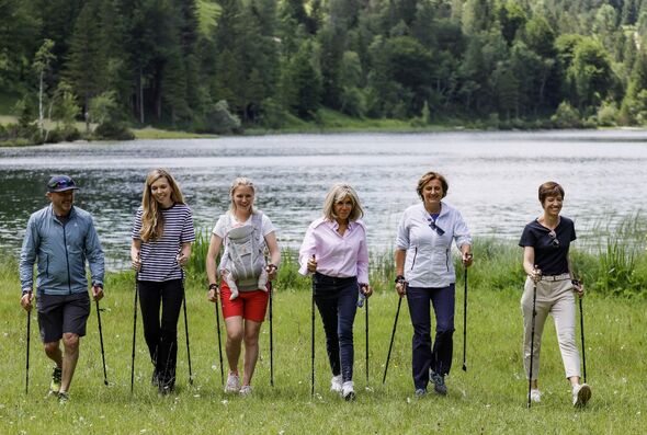 brigitte macron goes nordic walking with g7 wives in chic pink shirt and platform trainers