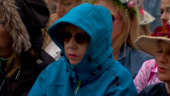Glastonbury: Hooded woman watches Robert Plant perform