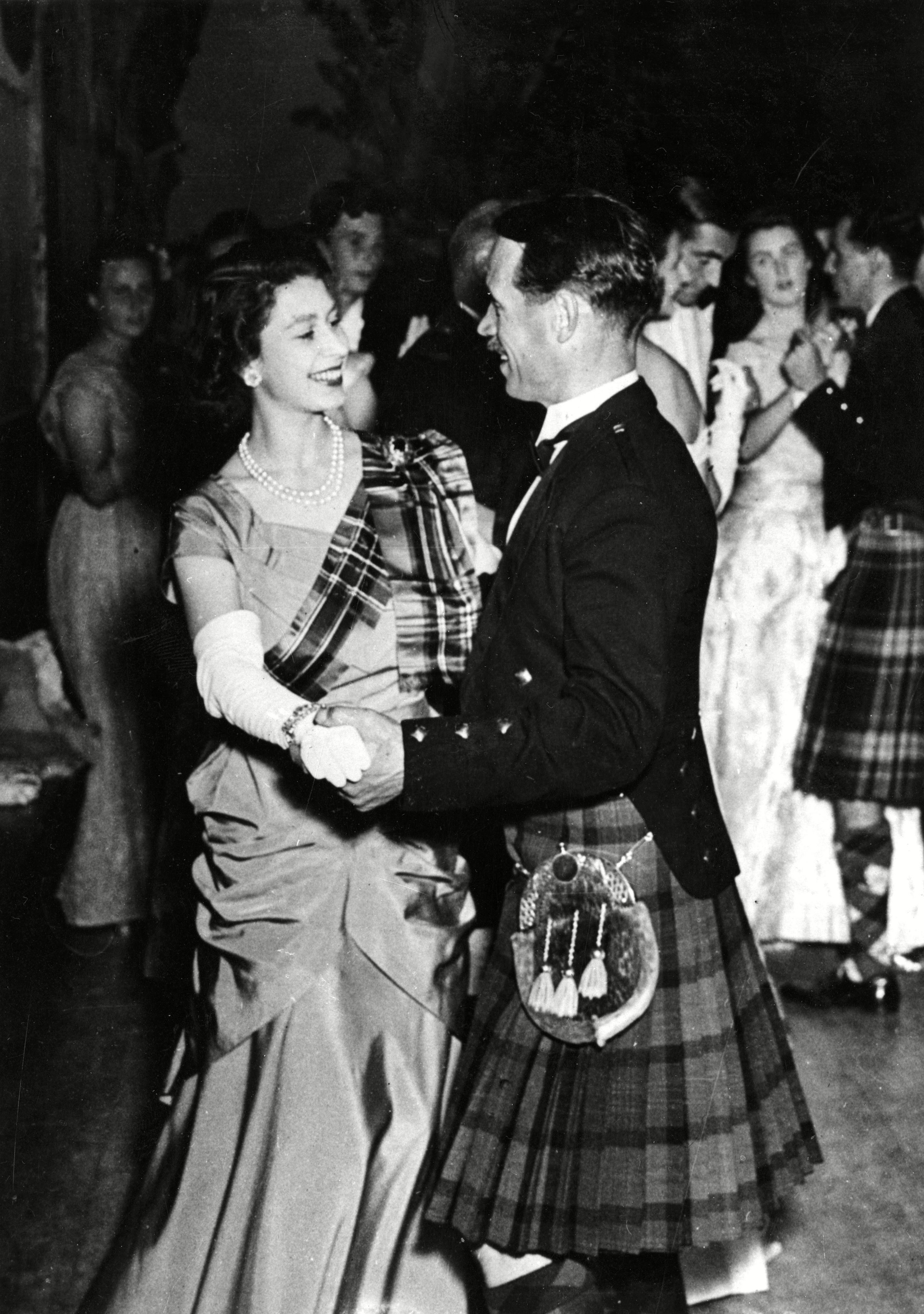 <p>Princess Elizabeth wore a lime green gown with a Royal Stewart tartan sash as she danced the quick-step with Mr. David Bogle at the Aboyne Ball in the Victory Hall Aboyne in Aberdeenshire, Scotland, in November 1949.</p>