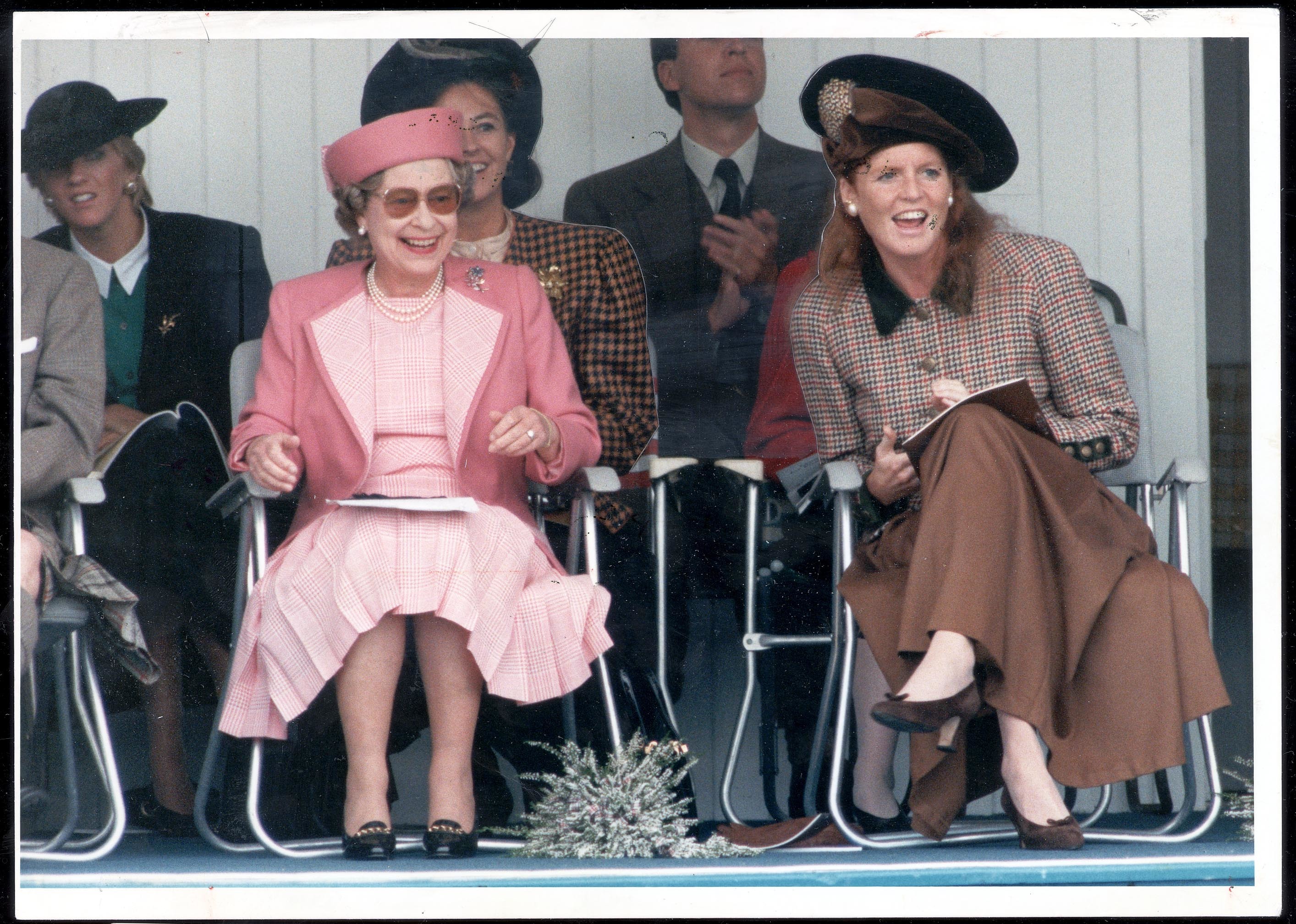 <p>Queen Elizabeth II and daughter-in-law Sarah, Duchess of York -- whose divorce from Prince Andrew would be finalized six years later -- marked the end of the Balmoral summer season with an appearance at Scotland's Braemar Highland Games on Sept. 1, 1990.</p>