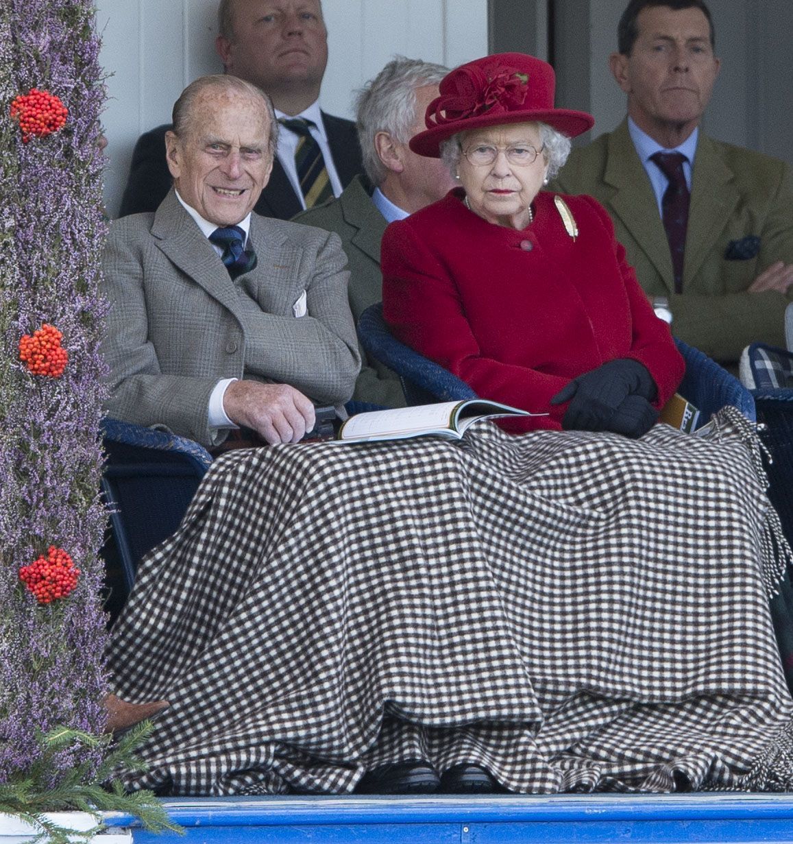<p>Keeping cozy! Prince Philip, Duke of Edinburgh, and Queen Elizabeth II cut the chill with a sturdy plaid blanket as they watched the Braemar Gathering at the Duke of Fife Memorial Park in Braemar, Scotland, on Sept. 5, 2015.</p>