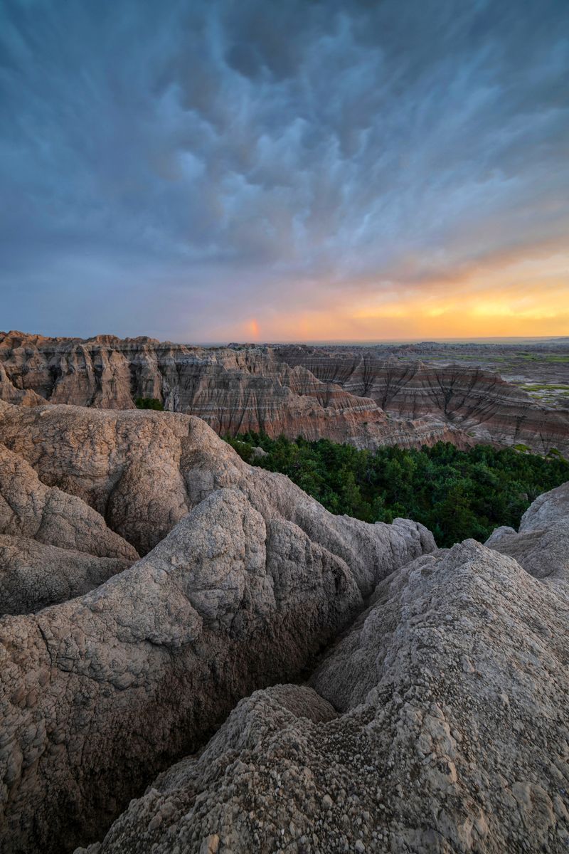 <p>                     In America’s heartland, near the western edge of South Dakota, you’ll find Badlands National Park, one of the most inexplicable landscapes in the country. With a martian-like scenery that boasts abundant wildlife in a maze of buttes and canyons, majestic granite spires, pine-covered peaks and unique rock outcroppings, the Badlands are a testament to the power of nature. Nothing compares to witnessing the "magic" hours of sunrise and sunset in the Badlands. As subtle shades of red and yellow transition into deeper and richer colors across the land, the sunset casts dramatic shadows off of the pinnacles and painted gullies. Cedar Pass Lodge, located just next to the Ben Reifel Visitor Center in Badlands National Park, offers cabins, tents, and RV sites and group camp sites.                   </p>