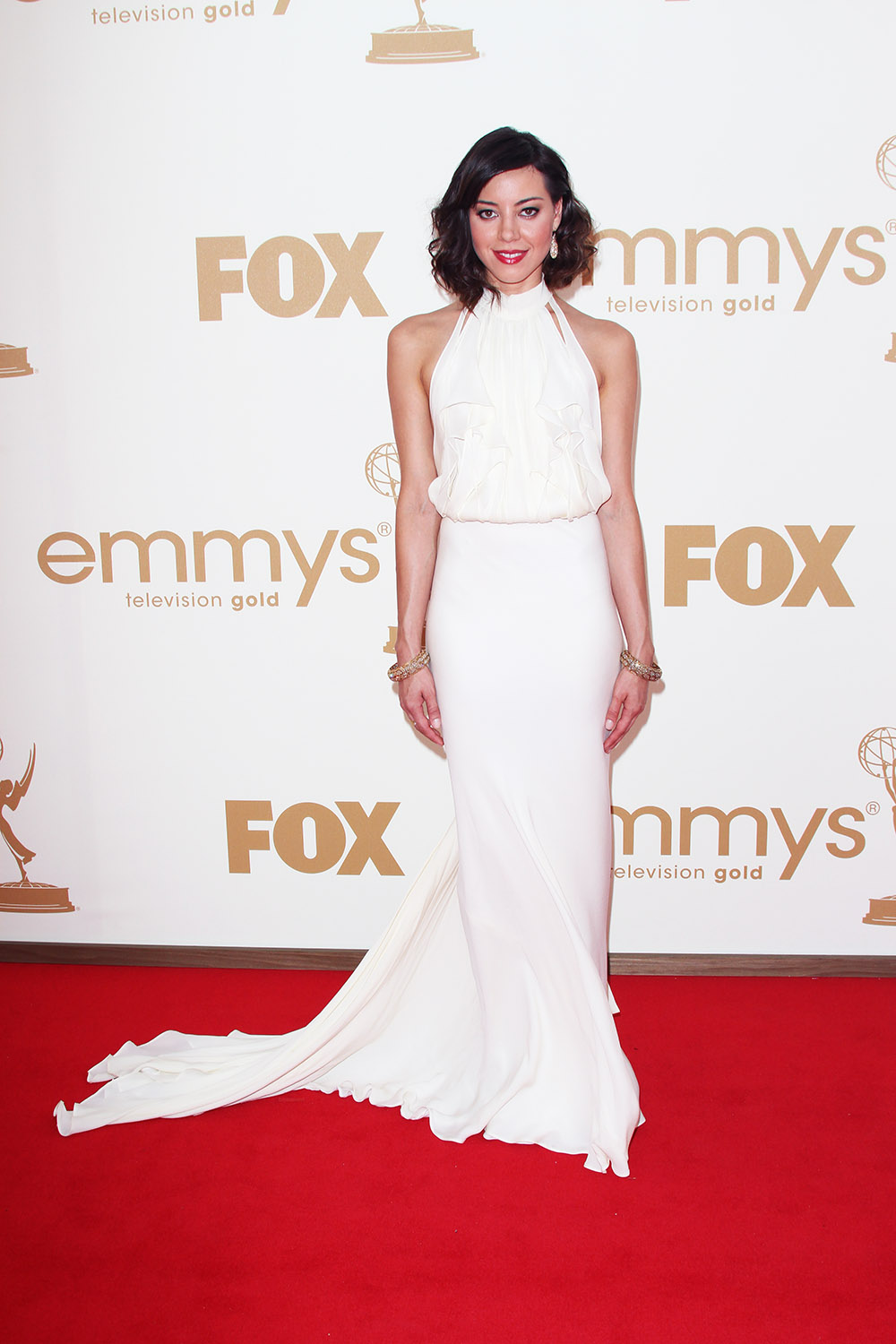 <p>Aubrey Plaza is radiant in white during the 63rd Annual Primetime Emmy Awards on Sep 18, 2011. Her high necked dress fell to the floor elegantly and she wore her brunette hair in a textured shoulder-skimming style. Arrivals, Los Angeles, America – 18 Sep 2011</p>