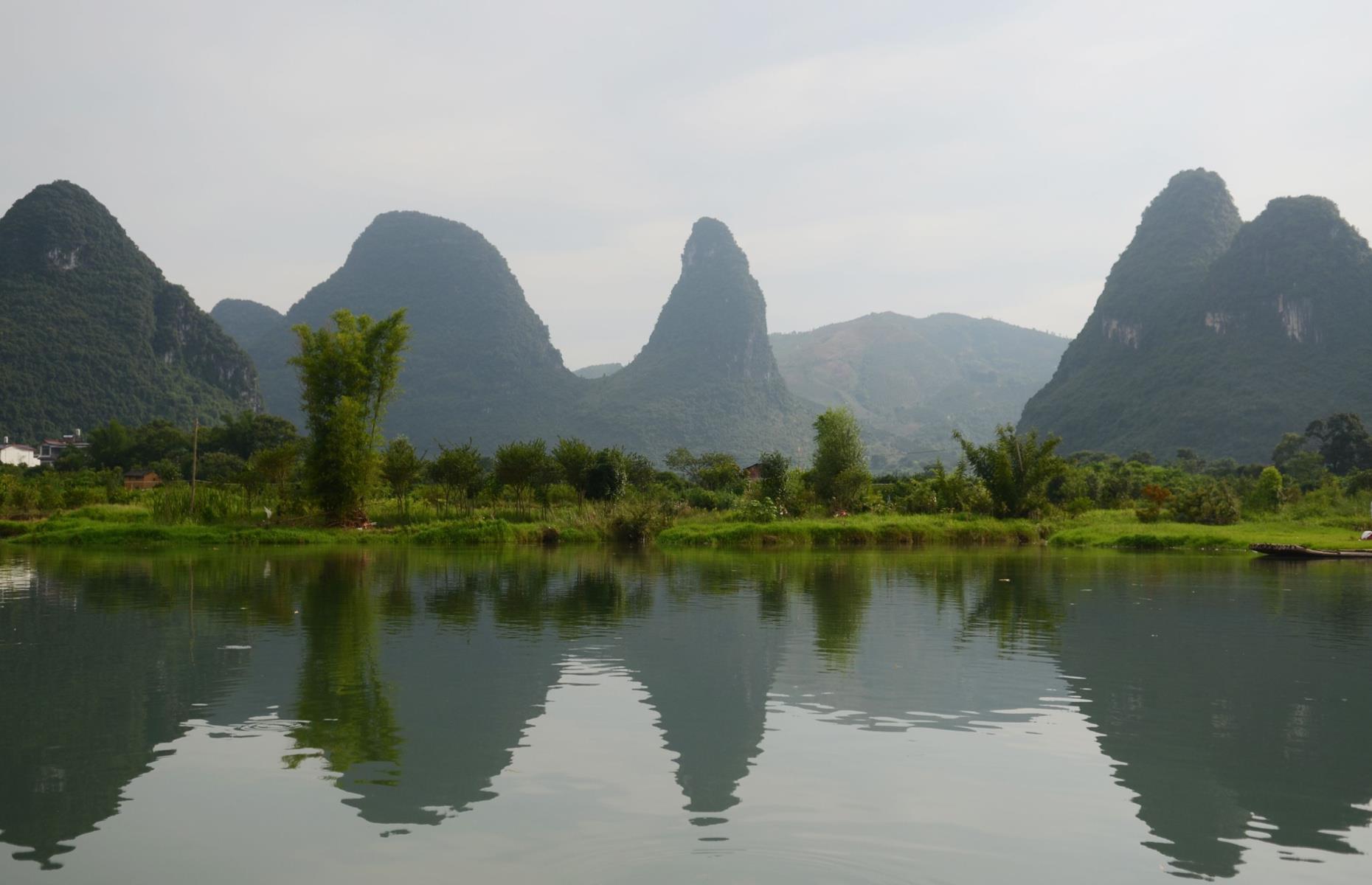 <p>Green fields and otherworldly mountains are hallmarks of the Chinese countryside, both of which are abundant in <a href="https://national-parks.org/china/guilin-lijiang">this park</a> located in the northeastern region of Guangxi Zhuang. The Li (or Lijiang) River flows through the park, creating some unforgettable vistas. Limestone mountain peaks complement the river, which is best enjoyed on a boat cruising along the water as it winds through the electric green landscape.</p>