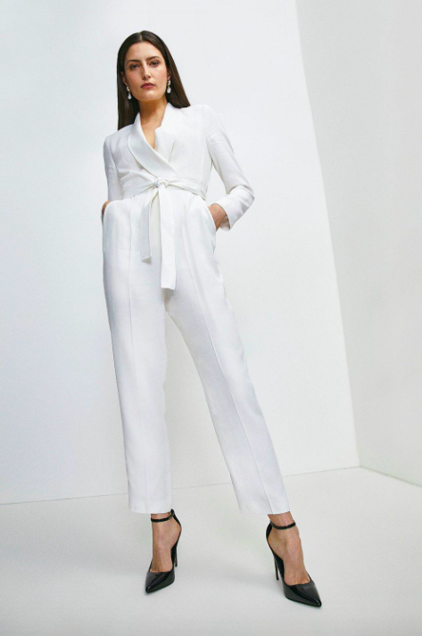 <p><strong>£159.20</strong></p><p><a href="https://www.karenmillen.com/tuxedo-belted-wrap-jumpsuit/AKK94298-4.html">Shop Now</a></p><p>Inspired by the a classic tuxedo jacket, this jumpsuit has a wrap-effect waist, a tie belt and shawl lapels. Consider this the softer option to wearing a full-on trouser suit.</p>
