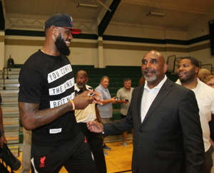 LeBron James shares a laugh with his former coach Dru Joyce II after the court dedication ceremony to name the court Coach Dru Joyce Court at LeBron James Arena at St. Vincent-St. Mary High School on Sunday in Akron.