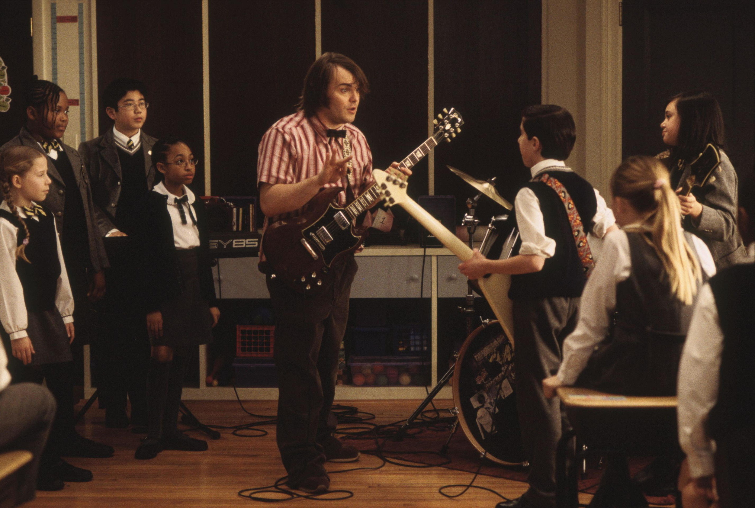 <p>White got the inspiration for <em>School of Rock</em> in part from the Langley Schools Music Project. Basically, back in 1970s, a teacher in British Columbia had recorded a bunch of kids at four schools in his district singing choral versions of pop hits of the time. It came out…kind of spooky. The records were not notable at the time, but in the early 2000s, they were discovered, released, and quickly became a cult object. This happened in 2001, and <em>School of Rock</em> would be released in 2003.</p>