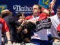 Joey Chestnut tackles a protester who interrupted the Nathan's Hot Dog Eating Contest.