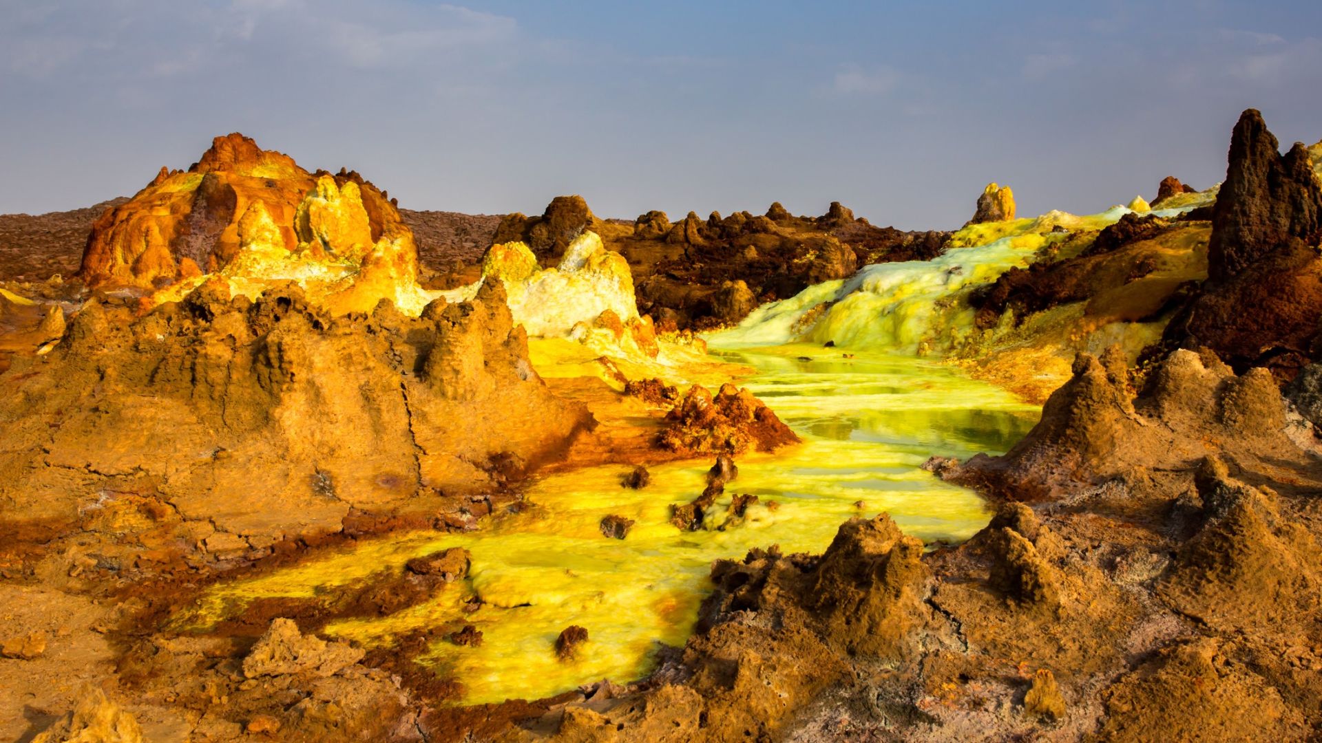 <p>                     The Danakil Depression, Ethiopia, is one of the most inhospitable and alien places on Earth. Known as the "gateway to hell" according to the BBC, the Danakil Depression is probably the closest you'll ever be able to come to standing on the surface of Venus (without the crushing atmosphere, of course). Choking sulphuric acid and chlorine gases fill the air, while acid ponds and geysers pepper the landscape.                    </p>                                      <p>                     According to the BBC, temperatures in this region regularly reach 113 degrees Fahrenheit (45 degrees Celsius), making it one of the hottest places on Earth.                   </p>                                      <p>                     The Danakil Depression lies over 330 feet (100 m) below sea level in a rift valley. Rift valleys are formed when tectonic plates move apart at a "divergent plate boundary," according to The Geological Society. The underlying volcanic activity sculpts the landscape as Earth is pulled apart at the seams. Some of the Danakil Depression features can even be seen from space, according to NASA Earth Observatory.                   </p>
