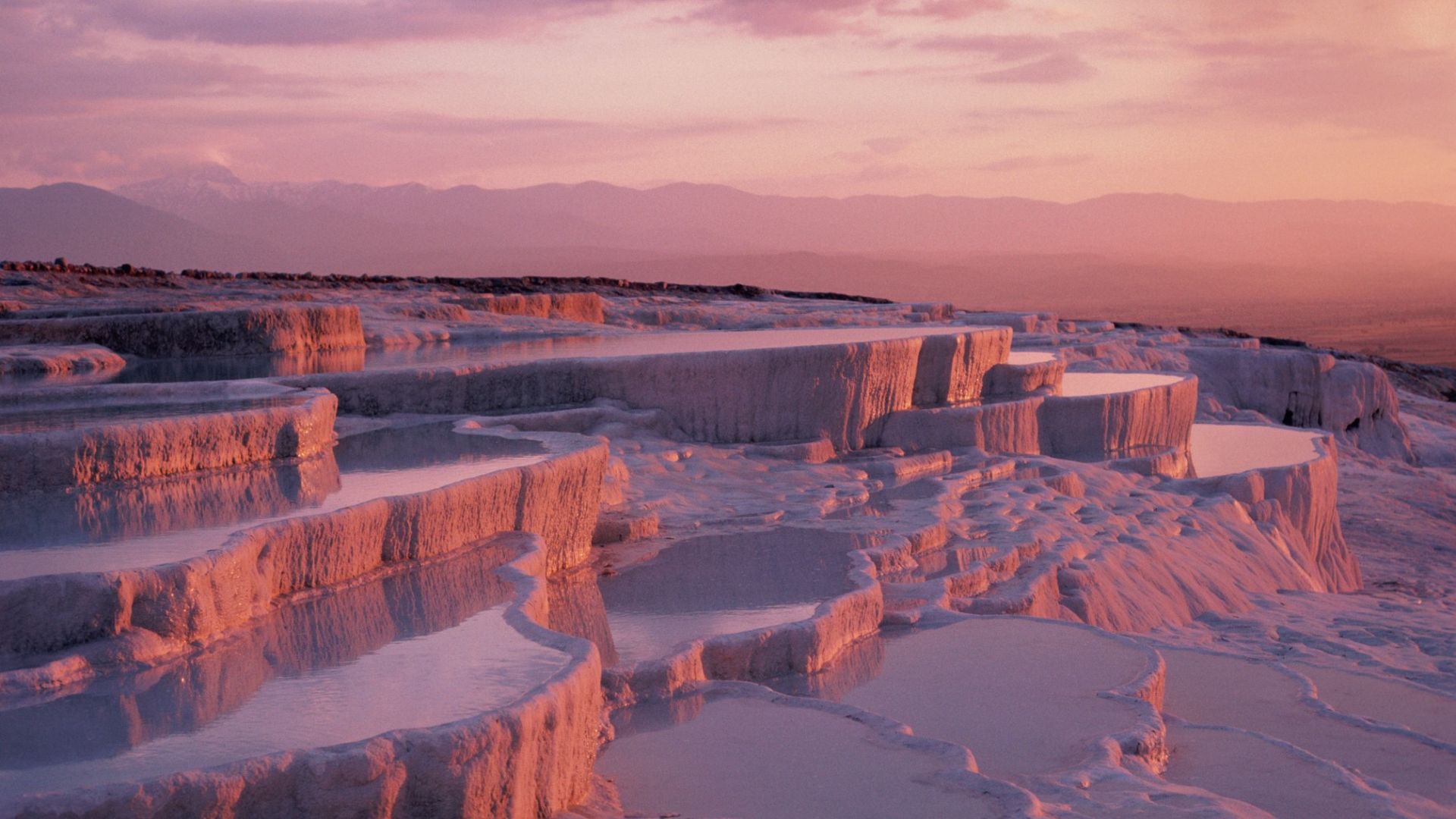 <p>                     Pamukkale, known as the "Cotton Castle" of Turkey, is a serene landscape dotted with mineral pools surrounded by white "cotton-like" shelves and ridges.                    </p>                                      <p>                     The unique landscape was created when a spring with a high concentration of calcium bicarbonate spilled over the edge of a cliff and cascaded down the side. The water leaves behind the white calcium deposits we see today, according to the Republic of Turkey Ministry of Culture and Tourism.                    </p>                                      <p>                     Tourists from far and wide flock to Pamukkale to relax in the calm waters and the myriad spas that have sprung up across the region.                    </p>