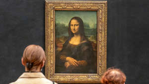 Visitors look at the Mona Lisa by Italian artist Leonardo da Vinci on display at the Louvre Gallery in Paris, May 19, 2021. Mark Piesecki / Getty Images