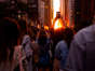 People photograph the Manhattanhenge sunset from East 42nd Street, Monday, July 11, 2022, in New York.