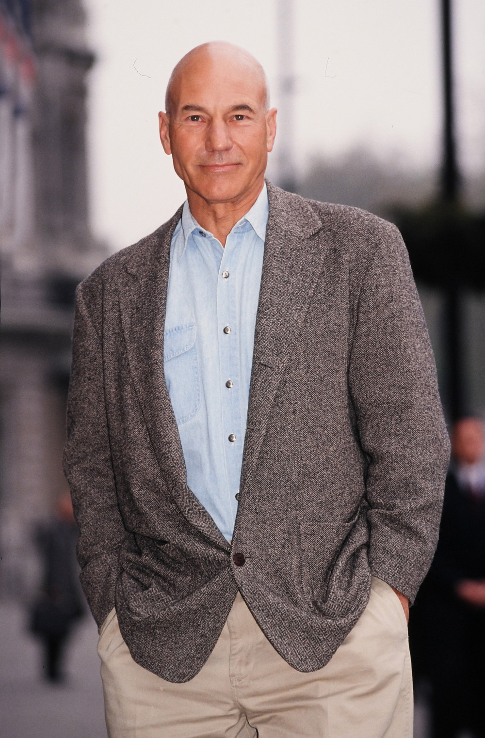 <p>Patrick Stewart c.1995. He looked rather dapper in his jacket, chambray shirt, and chinos.</p>