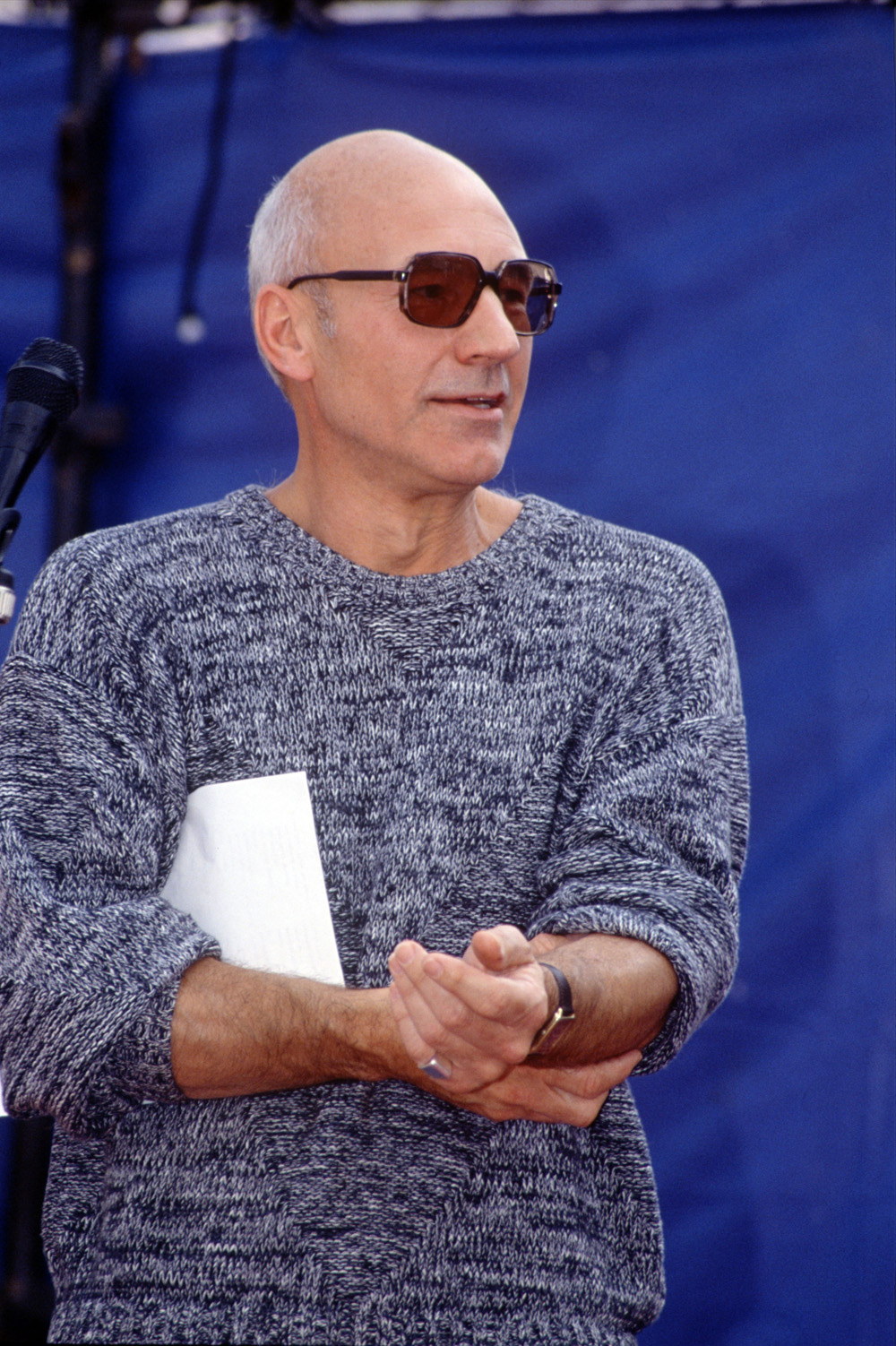 <p>Patrick Stewart attends a concert to Save the Rose Theatre in London’s Southwark neighborhood in 1989. He wore a heathered sweater and cool sunglasses.</p>