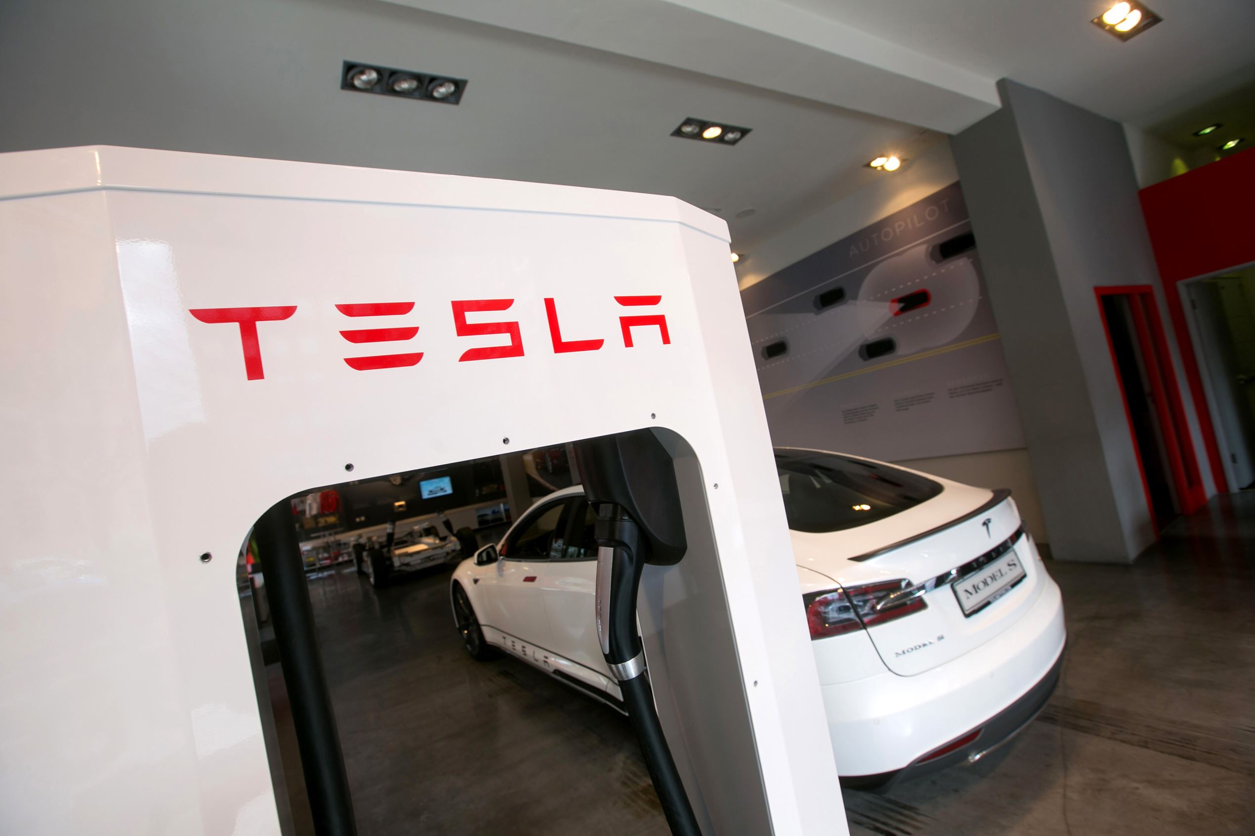 A Tesla Motors Inc. Model S P85 electric automobile stands connected to a charger inside a Tesla store in Munich, Germany, on March 30, 2015.