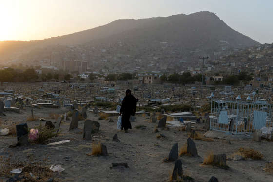 An Afghan woman makes her way home in a neighbourhood in Kabul on September 18, 2013. According to the World Bank more than a third of the population of Afghanistan live below the poverty line, more than half are vulnerable and at serious risk of falling into poverty. AFP PHOTO/SHAH Marai (Photo credit should read SHAH MARAI/AFP/Getty Images)