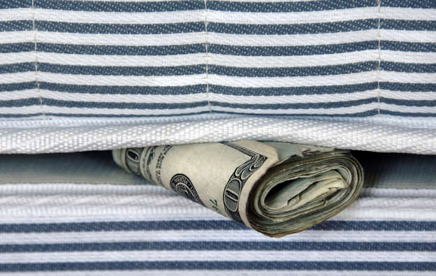 Roll of money under mattress.