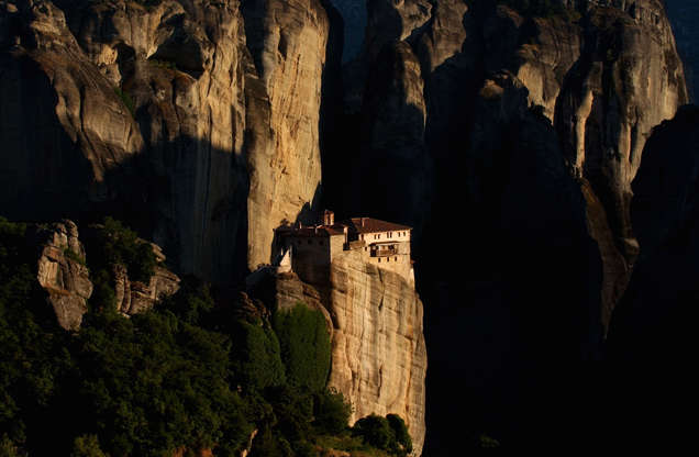 ÎÎ¹Î±ÏÎ¬Î½ÎµÎ¹Î± 1 Î±ÏÏ 42: The monastery of Saint Varvara Rousanou at the top of a huge rock is seen as the sun sets in Meteora, 350 kilometers (219 miles) north of Athens, central Greece, on Sunday, June 12, 2005. The ancient orthodox Christian monastic community in Meteora is situated on top of vertical rock formations that average 1,000 feet in height and is one of Greece's holiest sites as well as one of the country's environmentally protected areas.