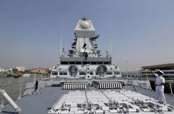 File: An Indian Navy personnel gestures on the deck of the newly built INS Kochi, a guided missile destroyer, during a media tour at the naval dockyard in Mumbai, India September 28, 2015. The warship which will be commissioned on Wednesday is the second ship in the Indian Navy to have multi-function surveillance and threat alert radar to provide information about targets for a long-range surface-to-air missile system, according to a media release issued by the Indian Navy.